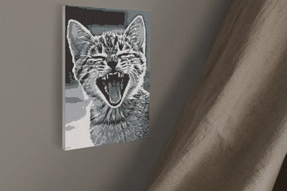 Canvas print of a cat's face with an open mouth on a wall.