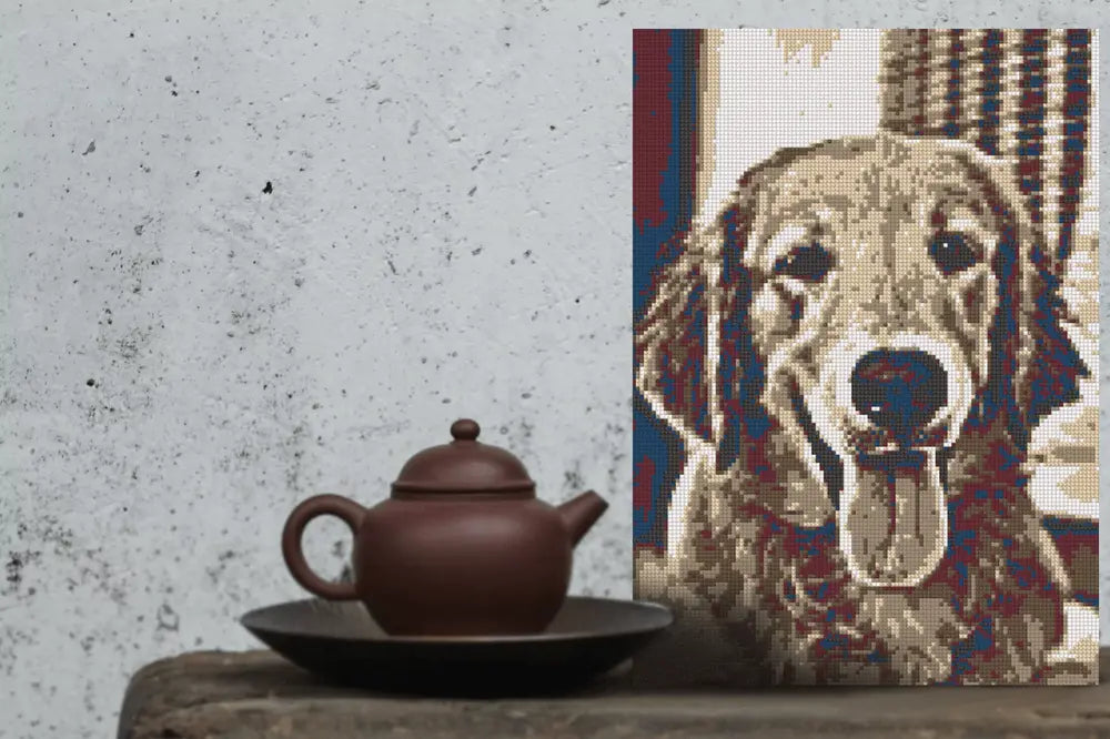 Tea pot on a wooden surface next to a woven mat with a dog's face design.