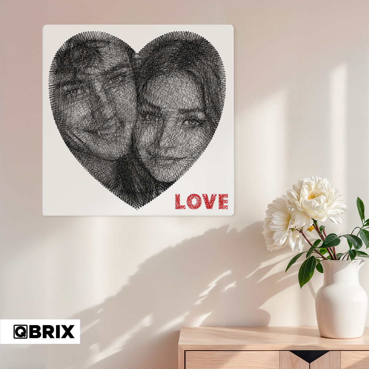 Finished heart-shaped QBRIX string art picture of a couple displayed on a wall